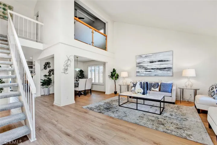 Gorgeous Formal Living Room and Formal Dining Room. New Wood Vinyl Flooring, 2-Story Ceilings, Dual Pane Windows, Plantation Shutters.