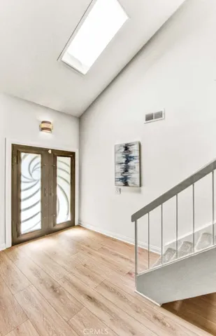 Dramatic Foyer with Soaring Ceiling and Skylight