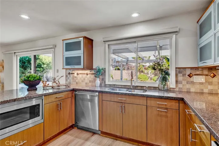 Remodeled Gourmet Kitchen with Caesarstone Quartz Countertops, Breakfast Bar, Stainless GE Monogram Appliances (5-Burner Gas Cooktop, Electric Oven, Microwave, Dishwasher), and Custom Soft-Closing Cabinetry with Pull-Outs, Hidden Recycle Trash, Lazy Susan, and Other Specialty Spaces