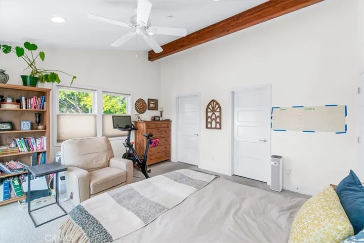 Master bedroom with beam ceiling, and ceiling fan. Walk-in closet too.