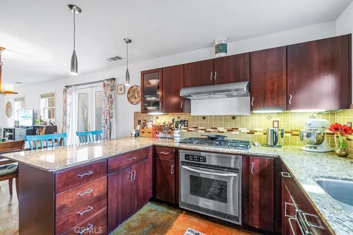 Beautiful and elegant kitchen with granite countertops and custom cabinetry.