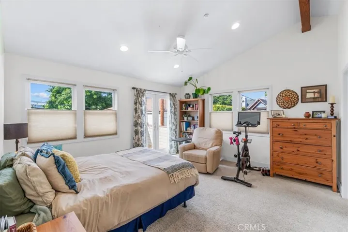 Master bedroom with french doors leading to balcony/deck.