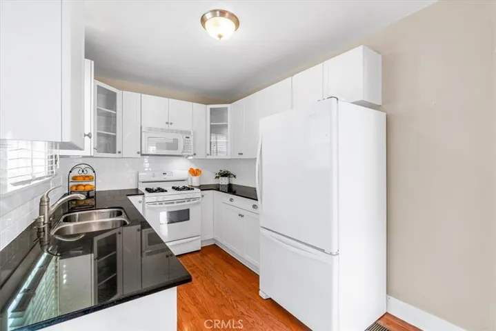 Amazing updated kitchen w/quartz countertops & lovely wood cabinetry.