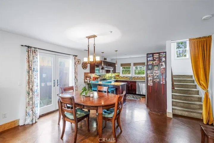 Stained concrete flooring w/tile accents on lower level.