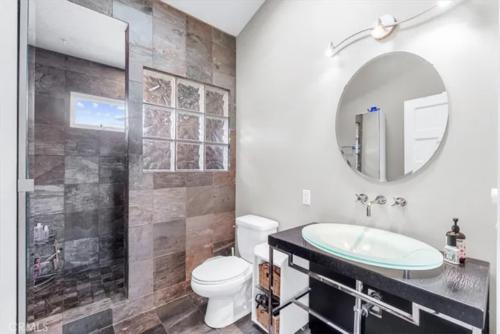 Master bath with dramatic slate and glass block accents.