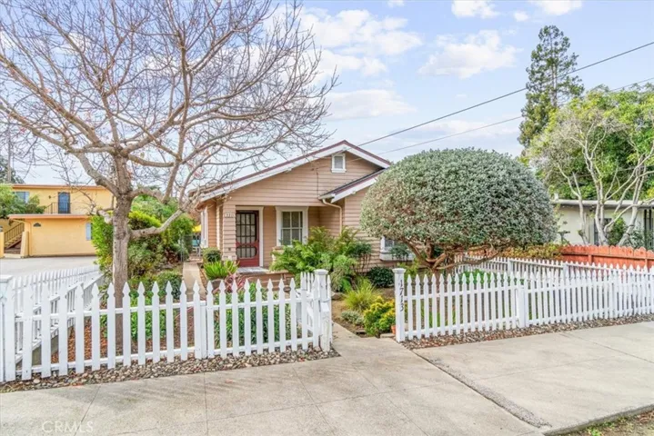 Adorable white picket fence. Lovely mature lanscaping.