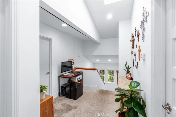 Upper level loft area with beam ceiling and sky light. (All Bedrooms and bathrooms on upper level) Carpet in all bedrooms, loft area and stairway.
