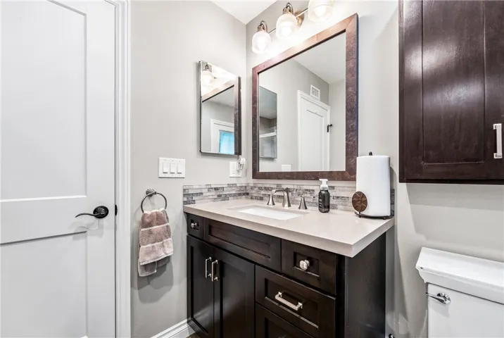 Main bathroom, completely remodeled, quartz counter top and custom vanity and storage.
