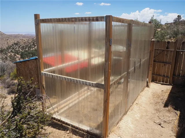 Greenhouse area. shed below and beyond the greenhouse.