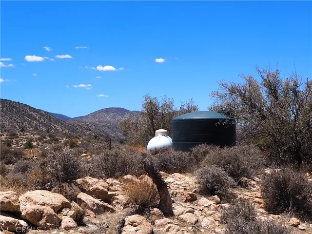 Storage tank for the hauled water and the propane tank tucked in beside it.