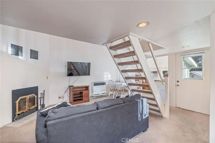 Studio cabin living room stairs lead to loft bedroom