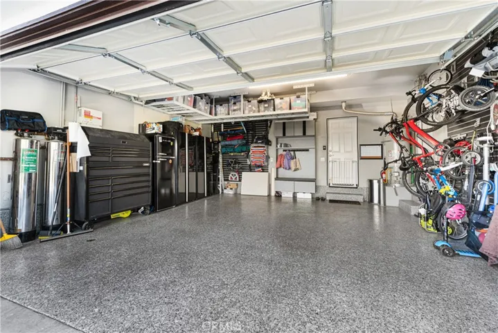 Garage has custom epoxy flooring, ample storage, Tesla back-up battery, whole house water filtration.