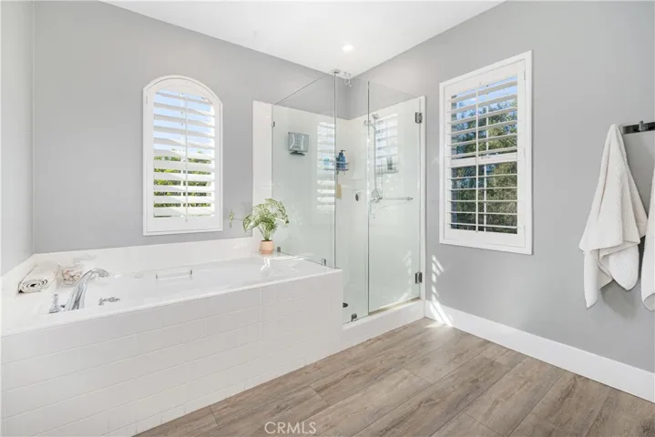 En-suite has a new dual sink vanity, custom wall, new flooring, separate shower, soaking garden bathtub.