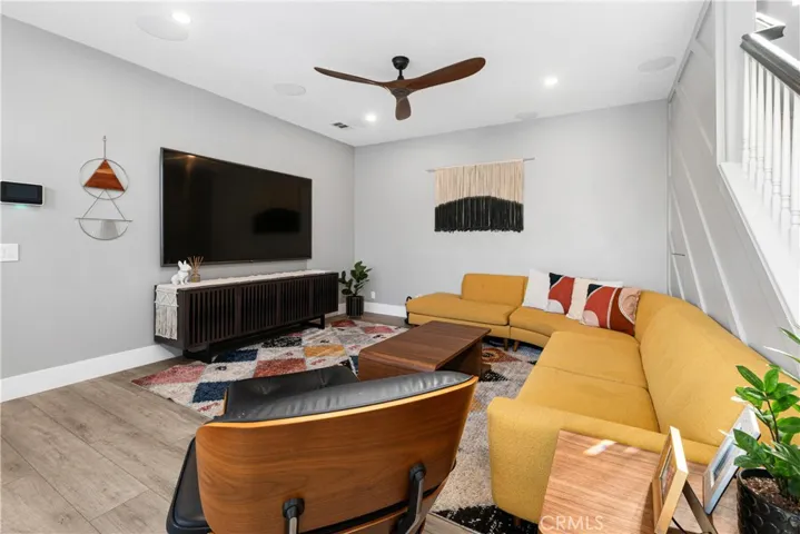 Family room has surround sound, ceiling fan, French doors to outdoor veranda, recessed lighting, and new flooring.