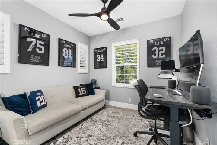 Additional bedrooms have custom shutters, ceiling fans, and fresh paint.