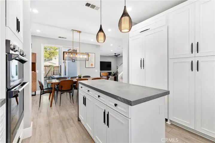 Designer kitchen with high end appliances including Thermamdor refrigerator, custom counter tops, custom backsplash, new cabinet doors, new flooring, and wine refrigerator.