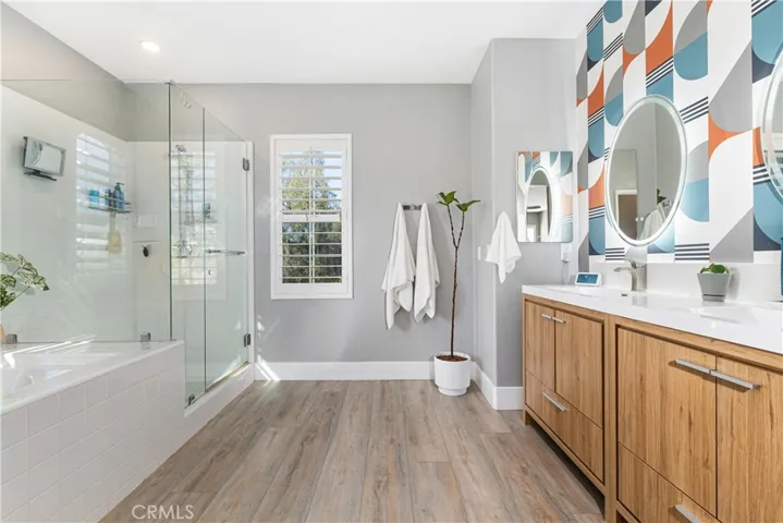 En-suite has a new dual sink vanity, custom wall, new flooring, separate shower, soaking garden bathtub.