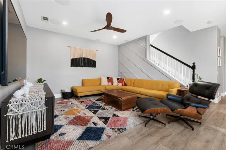 Family room has surround sound, ceiling fan, French doors to outdoor veranda, recessed lighting, and new flooring.