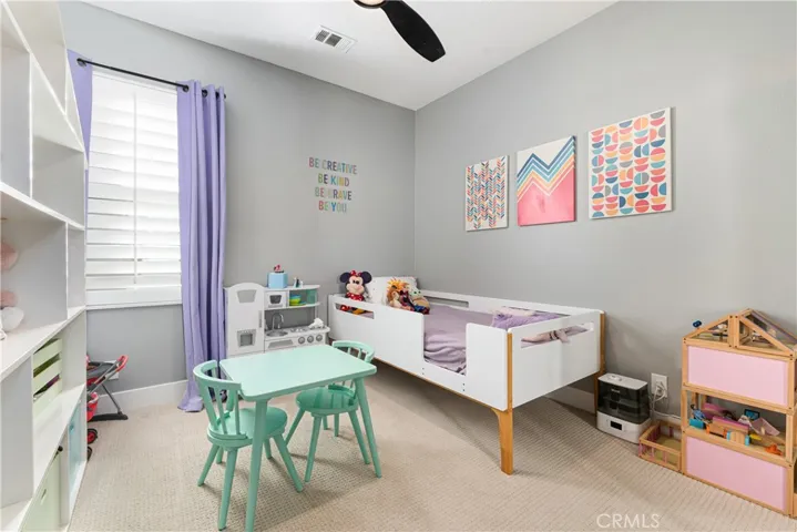 Additional bedrooms have custom shutters, ceiling fans, and fresh paint.