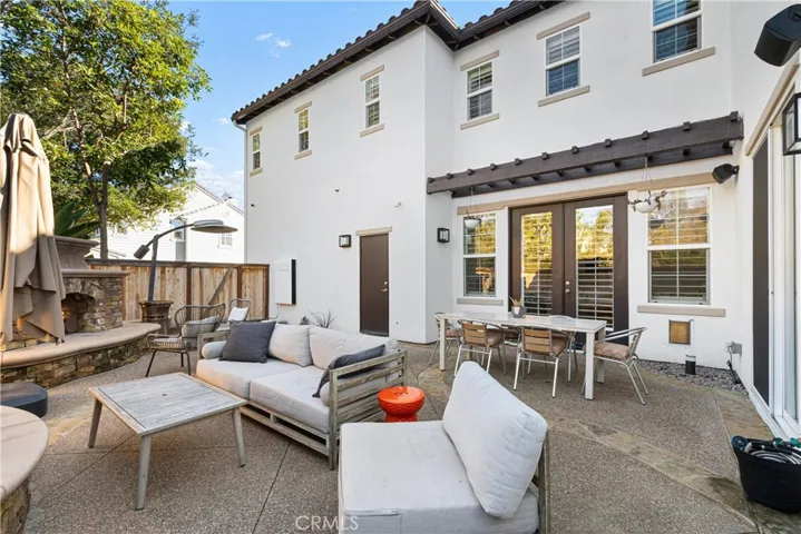 Entertainers backyard with large fireplace, custom outdoor kitchen with grill/smoker, refrigerator, outdoor tv.