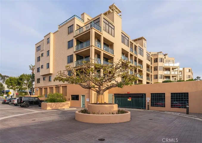View of Seascape Two with guest parking and gated garage entrance