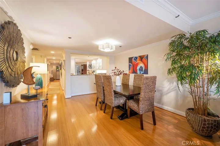 Dining room with view to the kitchen and entrance to the unit at the end of hallway. Bedrooms are on the left side