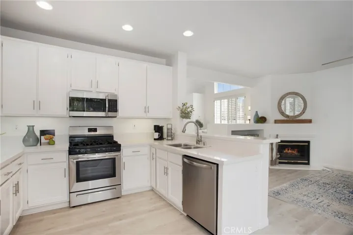 Kitchen has breakfast bar and is open to family room