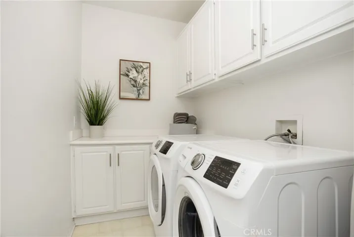 Upstairs laundry room with storage cabinets