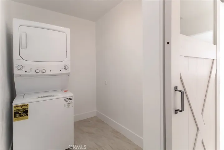 Brand new Stackable Washer/Dryer in Laundry area behind Barn Door