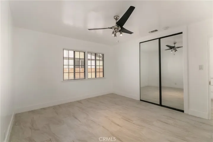 Large front Bedroom with ceiling fan & mirrored closet