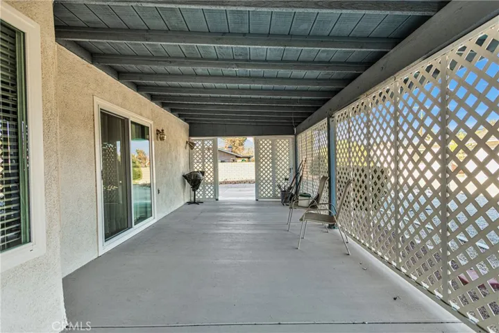 Extra long shaded back patio with new​​‌​​​​‌​​‌‌​​‌​​​‌‌​​​‌​​‌‌​​‌‌​​‌‌​​​​ windows.