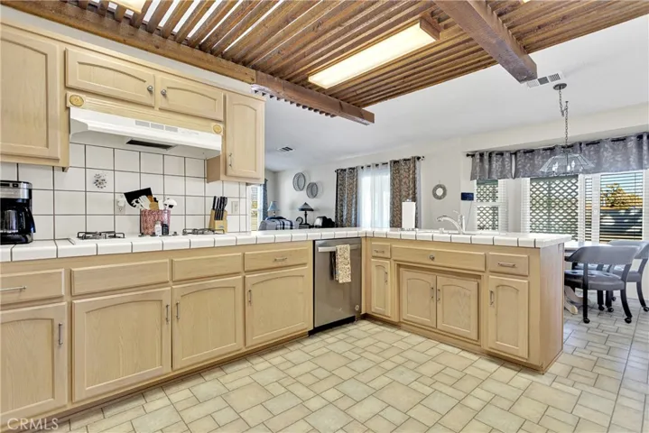 Open kitchen with rustic drop ceiling.