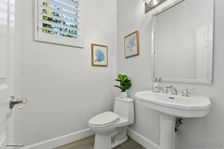 Beautifully refreshed vanity and half bath on first floor near formal dining room