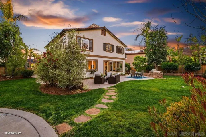 Remarkable entertainer's backyard on a spacious lot with multiple lounging areas, built-in bbq bar, half basketball court and raised herb garden