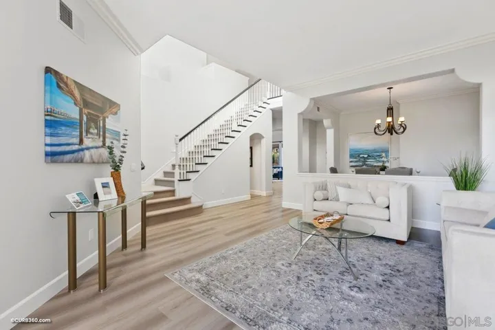 Tall enchanting Cathedral ceilings, lead to the sunlit  formal living area enveloped by windows with gorgeous plantation shutters and an open floorplan
