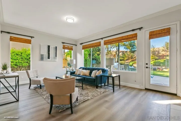 Bright and airy great room is great for growing families and opens to the backyard as well as the eat-in kitchen