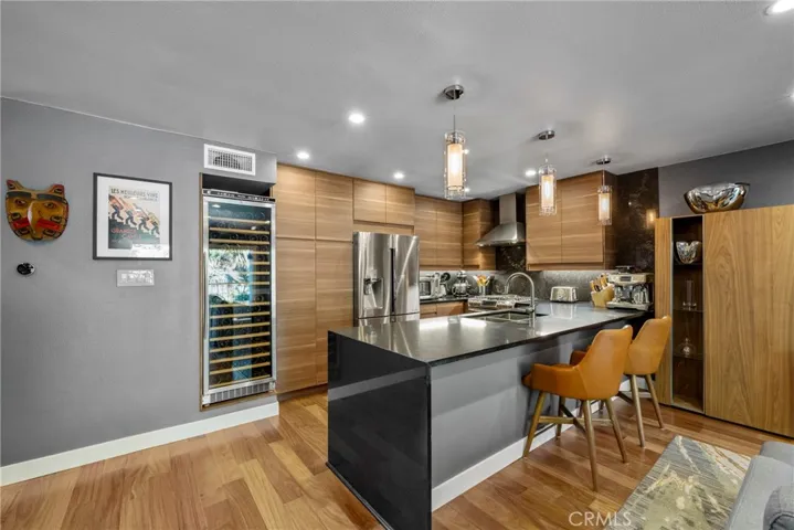 Glass Pendant Lighting over the Peninsula, Samsung and Bosch Appliances, and large Stainless Steel Kitchen Sinmk with Delta Trinsic Faucet!