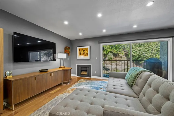 Fireplace in the Living Room and a Sliding Glass Door leads to the Back Pati/Deck.
