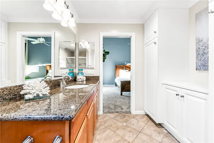 Granite countertops and large vanity with towel pantry and folding counter