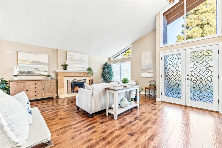 Living room with high ceilings and wood burning fireplace
