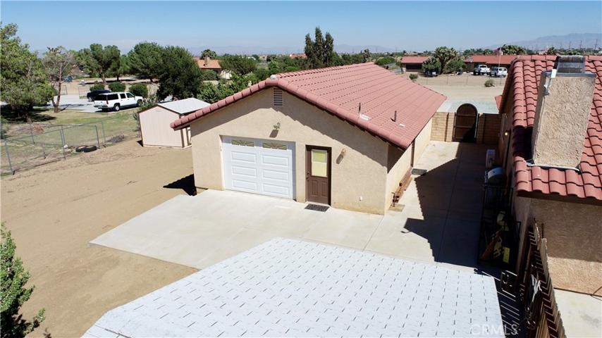 12-foot-wide concrete walkway between garage and house/office