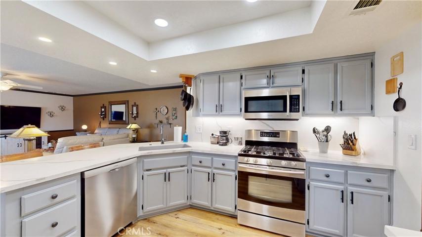 upgraded kitchen with quartz countertops and all new built in appliances. Udder cabinet lighting too.  large corner pantry.