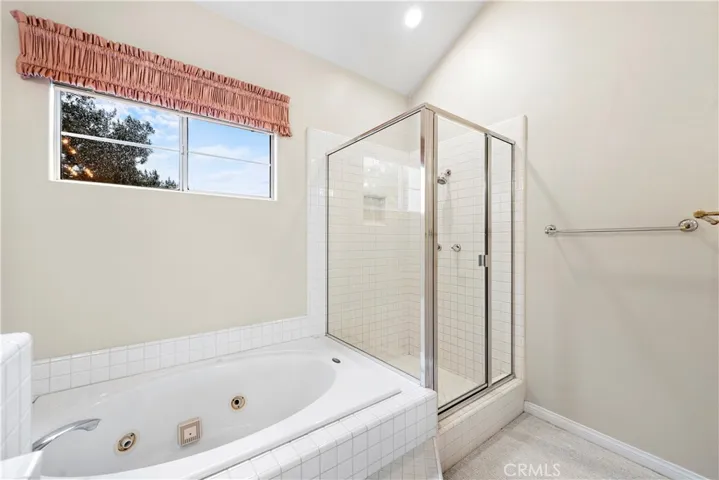 The primary bath has a separate spa tub and shower enclosure