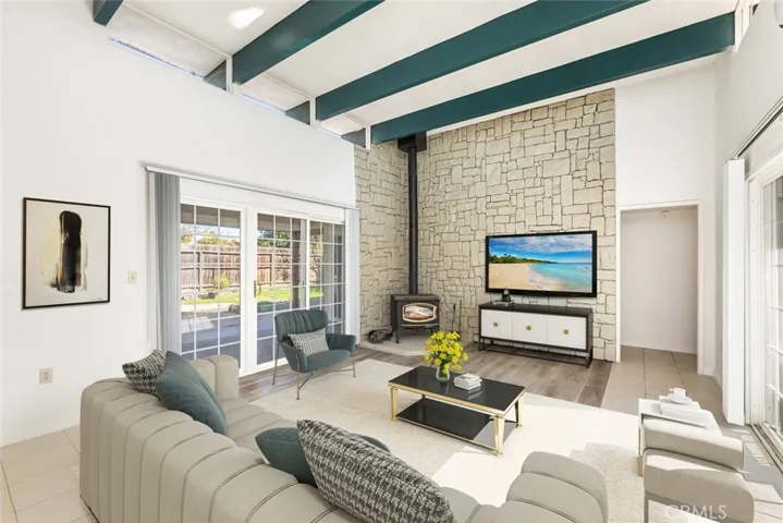 Open Living room area with tons of natural lighting (digitally staged)