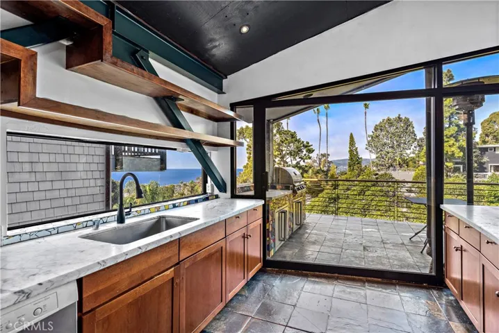 Kitchen opens to deck with built-in BBQ