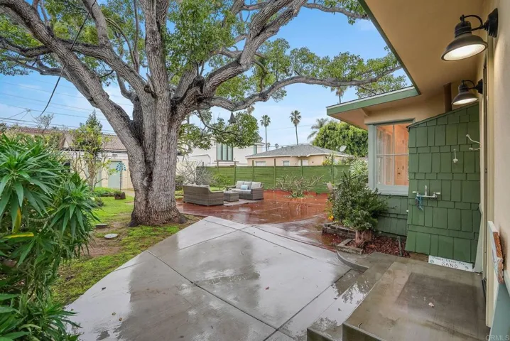 Huge back yard offers several places for tables, lounges, bbq