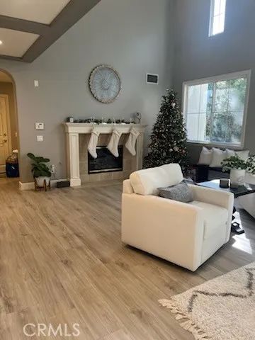 Living room with high ceilings and fireplace.