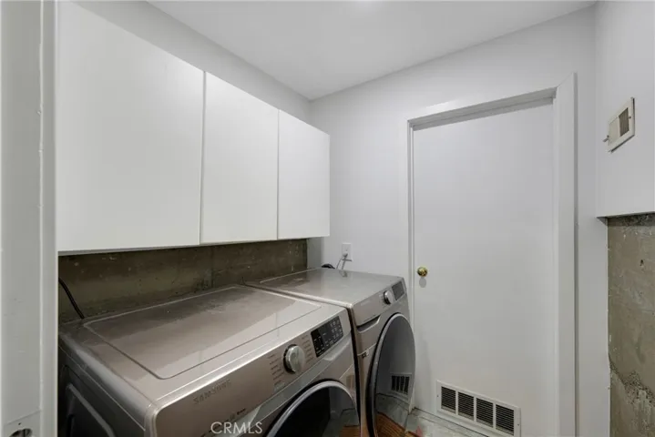 laundry room with storage room