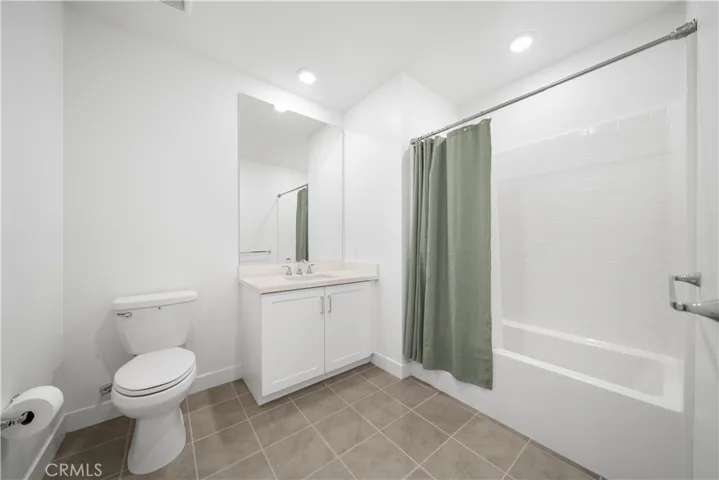 The 3rd  bathroom with tub and shower.