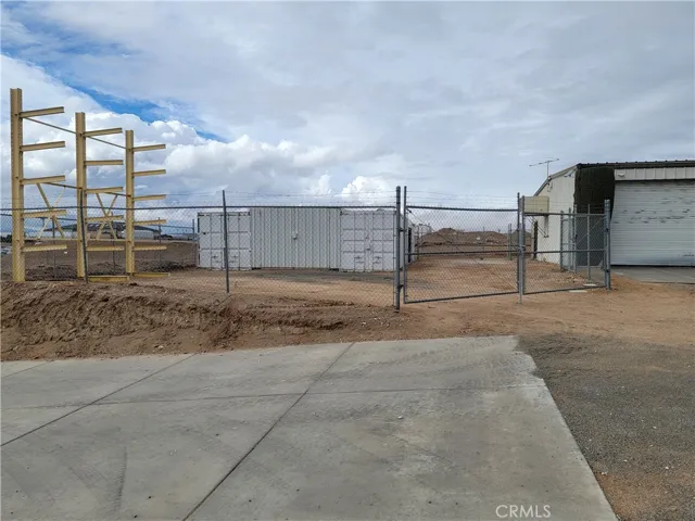 Storage area and driveway to the lower yard.